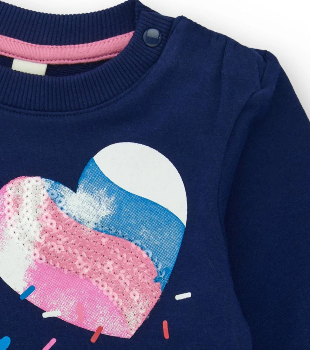 Felpa blu navy per bambina con cuore brillante e design posteriore asimmetrico.
