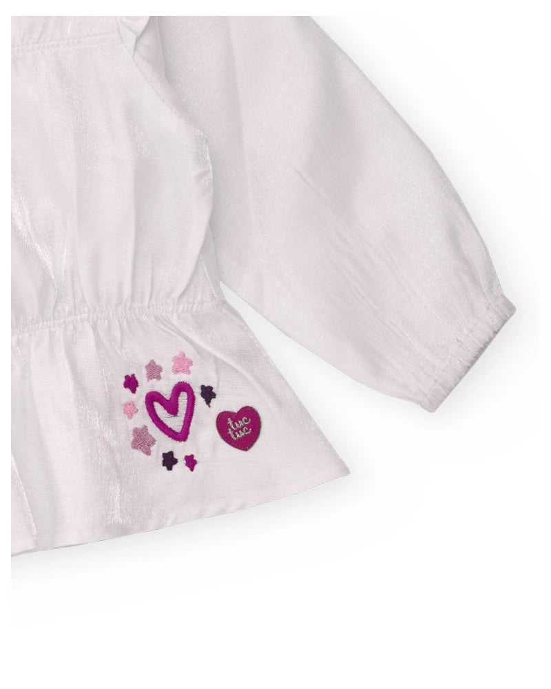 Blusa a maniche lunghe per bambina bianca con dettaglio di volant.