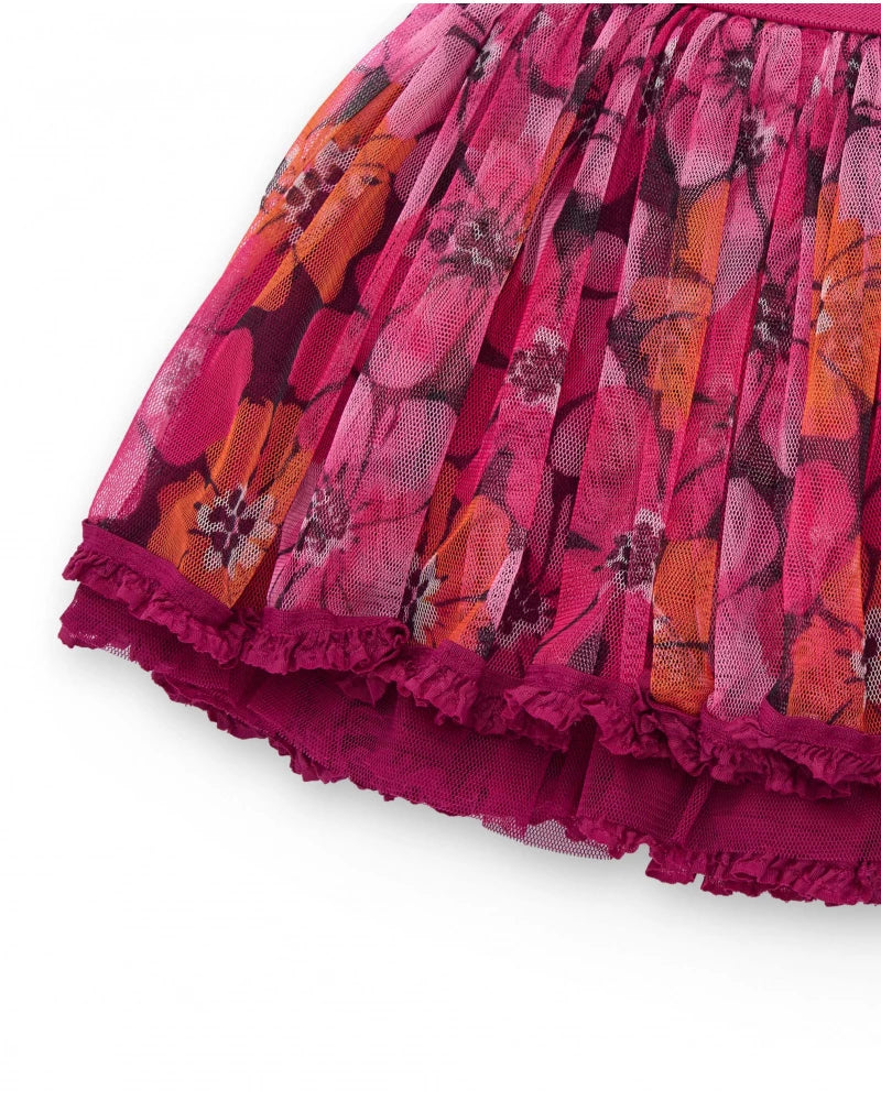Gonna per bambina in tulle plissé fucsia con stampa floreale.