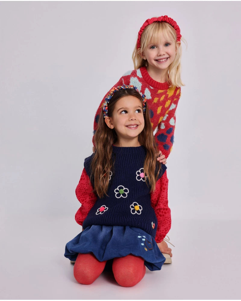 Gonna in denim per bambina con stampe colorate di fiori e cuori.