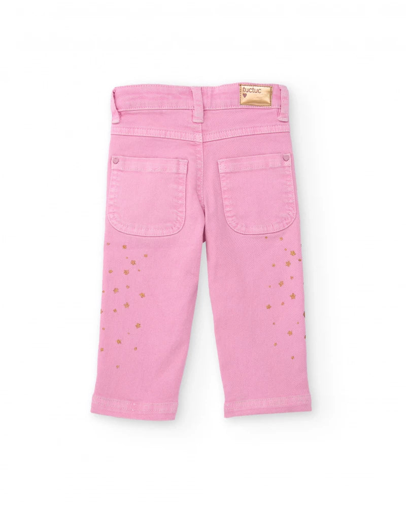 Pantaloni lunghi in twill stretch per bambina colore rosa con stampa di stelline dorate.