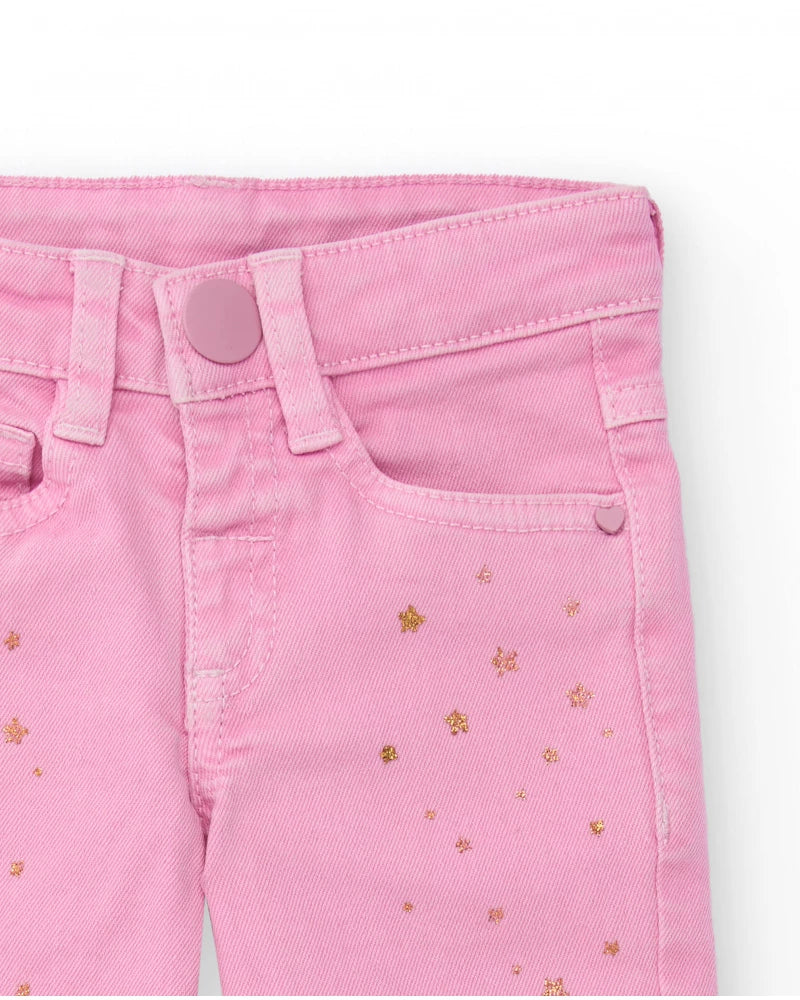 Pantaloni lunghi in twill stretch per bambina colore rosa con stampa di stelline dorate.