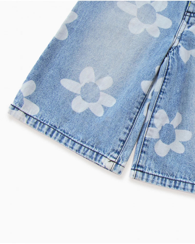 Pantaloni in denim blu da bambina con stampa floreale