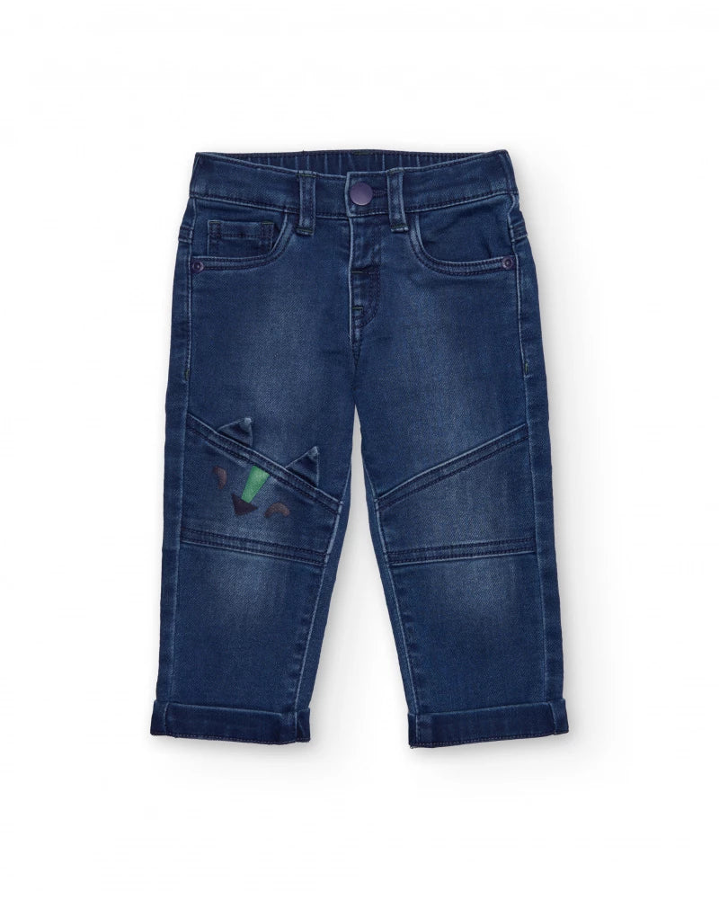 Pantaloni in denim blu per bambino con ricamo di dinosauro.