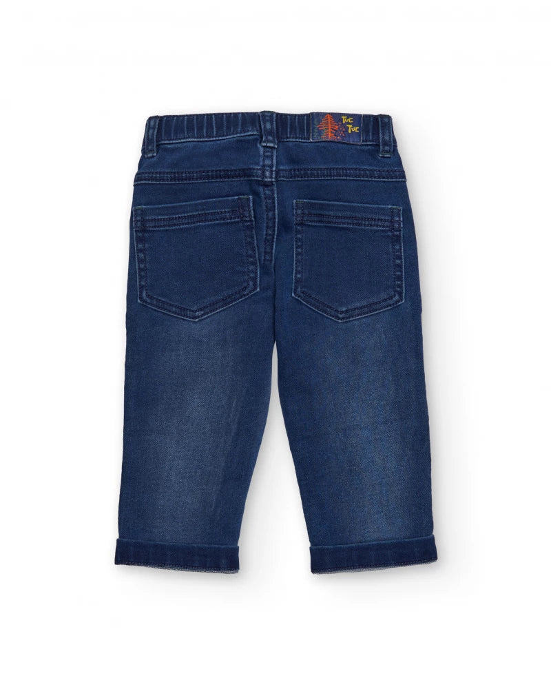 Pantaloni in denim blu per bambino con ricamo di dinosauro.