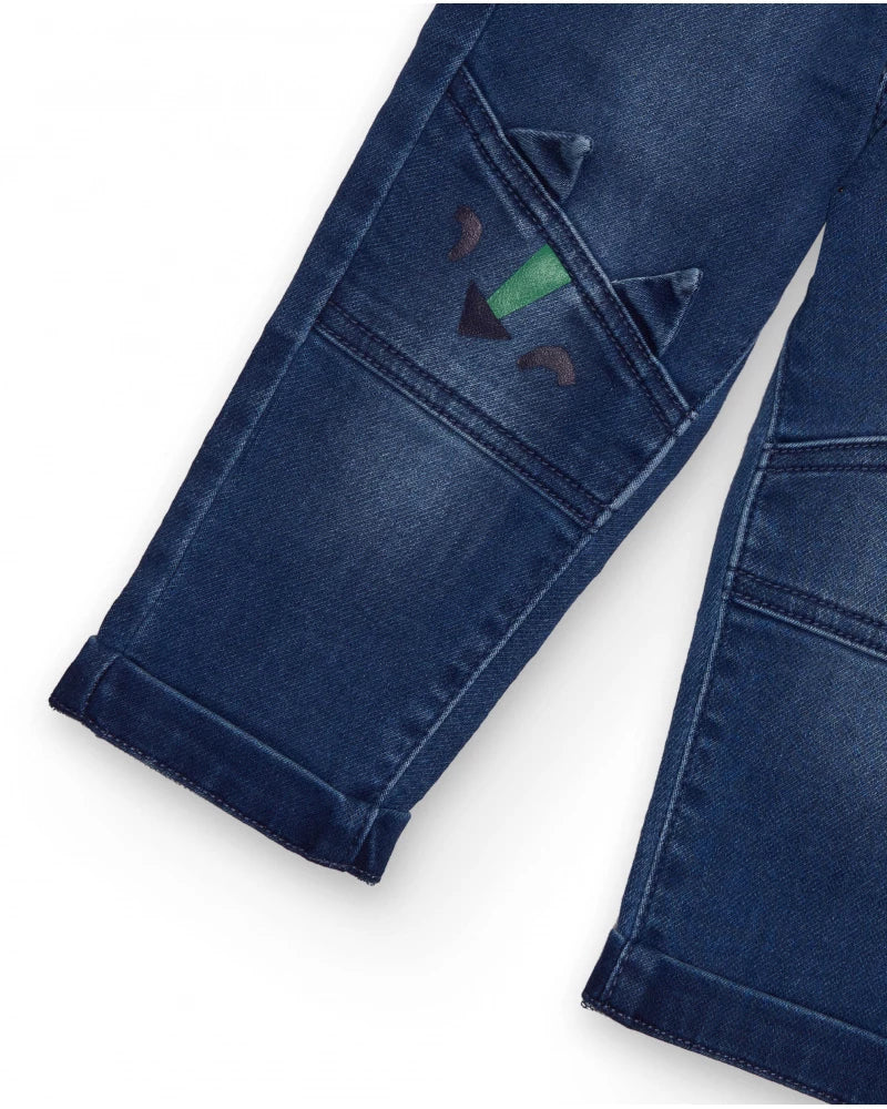 Pantaloni in denim blu per bambino con ricamo di dinosauro.